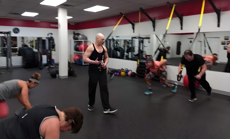 A group training class at Body by Phil with Phil coaching